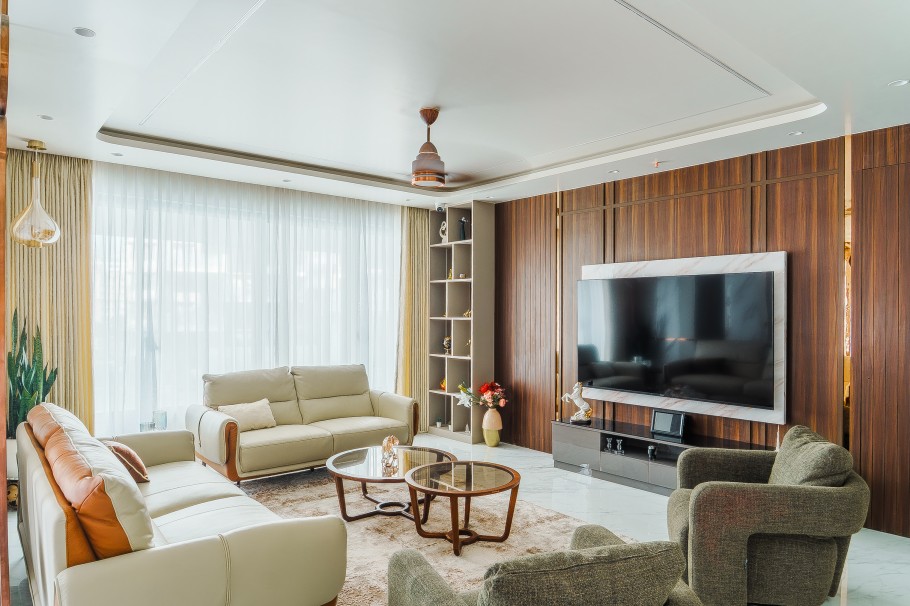 Modern luxury living room interior with sofa set, TV wall, glass coffee table, and large windows